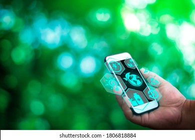 Hand Of Business Man Use Smart Phone, Ecology Sustainable Energy With Technology Concept On Blurred Gentle Artistic Nature Background, Free Space For Text. AI Futuristic Smart Interface.