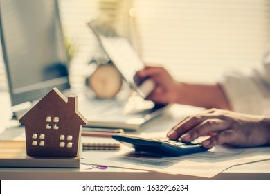 Hand of Business people calculating interest, taxes and profits to invest in real estate and home buying - Shutterstock ID 1632916234