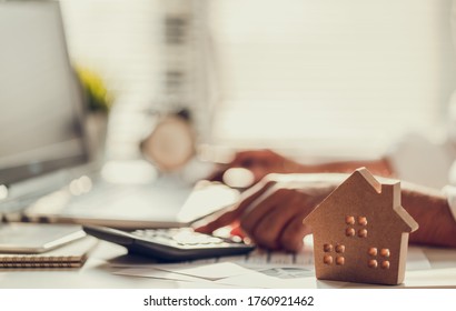 Hand of Business people calculating interest, taxes and profits to invest in real estate and home buying - Shutterstock ID 1760921462