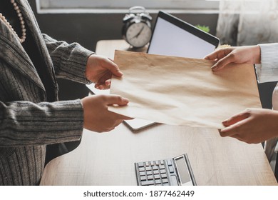 Hand Of Business Woman Giving Envelope To Colleague In Modern Office. Promotion, HR Concept, Unemployment Concept, Searching For Job, Envelope With Job Offer Message