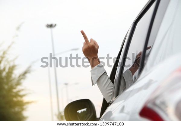 Hand business\
women in car and showing fuck\
you