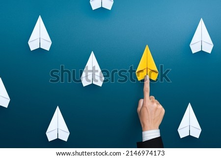 Hand of businessman choose yellow paper plane, Select leader or employees, Headhunting