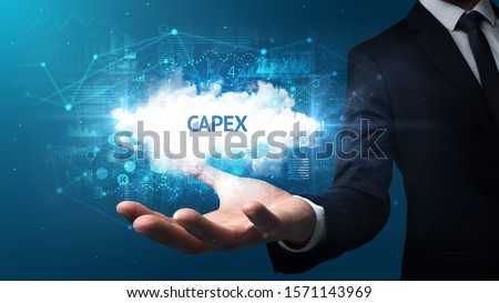 Hand of Businessman holding CAPEX inscription, successful business concept