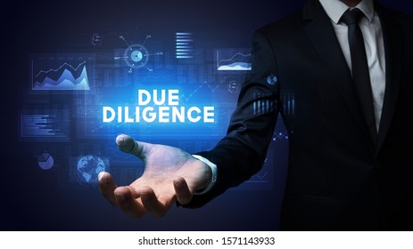 Hand Of Businessman Holding DUE DILIGENCE Inscription, Business Success Concept