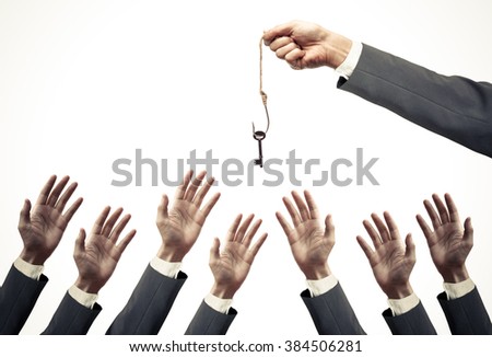 hand of a businessman holding a fish hook with a key over many hands of businessmen - opportunist concept