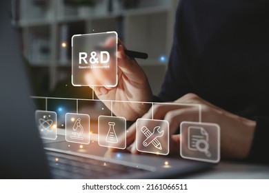 Mano de hombre de negocios sosteniendo un bolígrafo apuntando al icono de R y D para Investigación y Desarrollo en la pantalla de un portátil. Gestione los costos de manera más eficiente. Concepto de innovación en I+D.