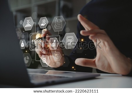 Hand of businessman holding a pen pointing to FEES on laptop screen, Business hidden money, service fee and tax concept.