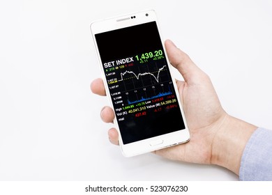 Hand Businessman Holding Smartphone  With Set Index Chart On White, Set Index Chart  On Smartphone Screen