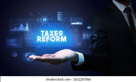 Hand Of Businessman Holding TAXES REFORM Inscription, Business Success Concept