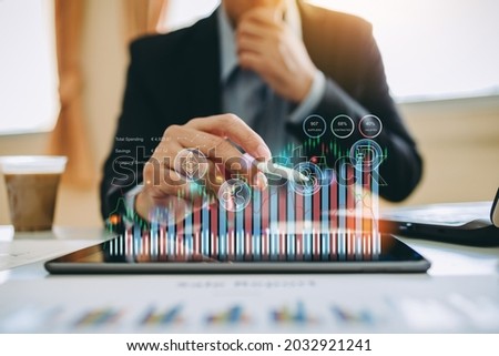 Hand of businessman interaction with artificial intelligence to invest bitcoin price digital chart exchange on tablet. Concept of cryptocurrency future money and nft of blockchain technology.