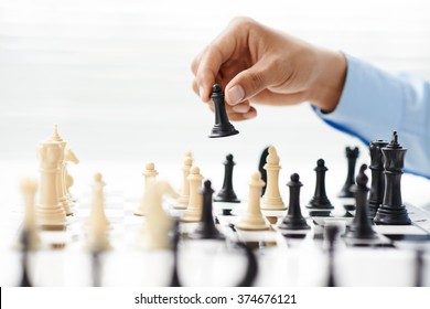 Hand Of Businessman Playing Chess