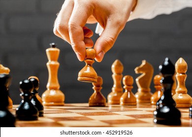 Hand Of Businessman Playing Chess