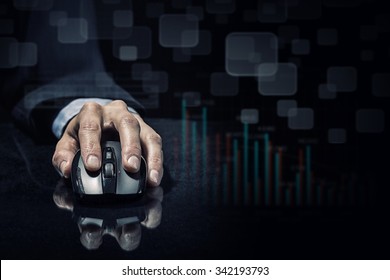 Hand Of Businessman In Suit On Dark Digital Background Using Wireless Computer Mouse