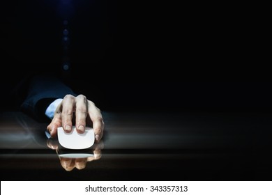 Hand Of Businessman In Suit On Dark Background Using Wireless Computer Mouse