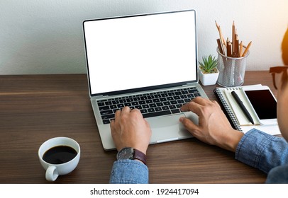 hand of businessman using keyboard of laptop computer blank screen. He is working business on table in office. Business investment-finance accounting concept. with copy space.