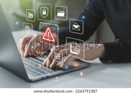 Hand of businessman using laptop with caution warning sign for notification error and maintenance concept.