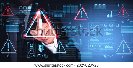 Hand of businessman using malware alert cybersecurity interface with triangular warning icon on touch screen over blue background. Concept of computer antivirus and data protection software