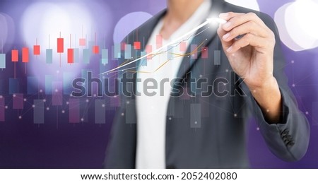 hand of businessman writing grapth and analyzing investment ,financial and sale marketing stock