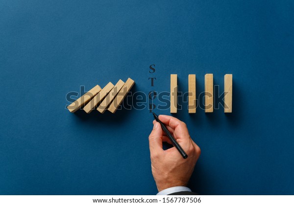 hand-businessman-writing-stop-word-between-stock-photo-edit-now-1567787506