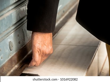 Hand Of The Businesswoman Opening The Old Rust Shutter Door.