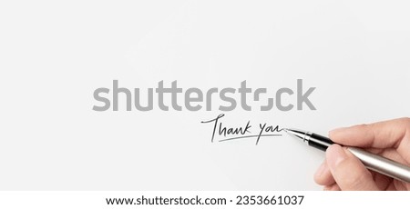 A hand of businesswoman writing on paper in the office. Hand writing thank you on piece of paper.