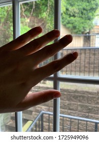 Hand by Window Staying Inside