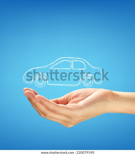 Hand with\
car against blue background. car\
insurance