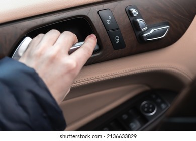 Hand With Car Door Handle Inside The Luxury Car Interior With Leather And Wood Design. Close-up View 