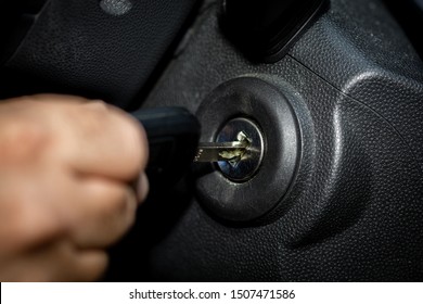 Hand With Car Key And Ignition Lock