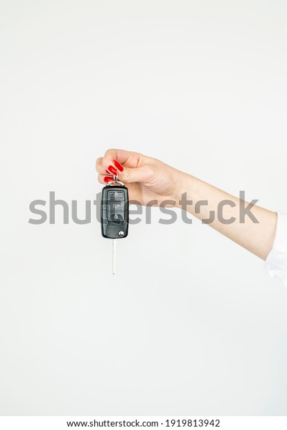 Hand with a car key.\
Space for your text.