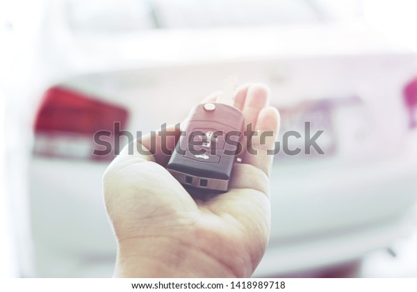 Hand with car keys The concept of selling cars\
and giving cars to\
customers