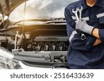 Hand of car mechanic with wrench. Auto repair garage. mechanic works on the engine of the car in the garage. Repair service. Concept of car inspection service and car repair service.