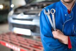 Hand of car mechanic with wrench. Auto repair garage., an Industrial Photo by Rohatynchuk Mykola