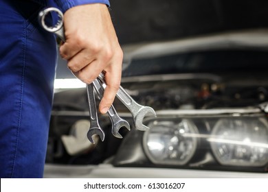 Hand Of Car Mechanic With Wrench. Auto Repair Garage.