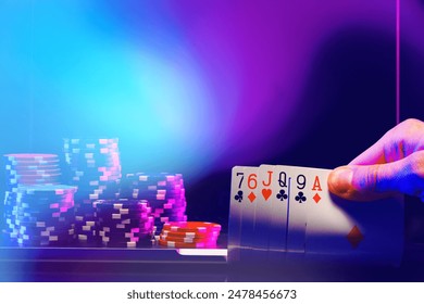 Hand of Cards and Stacks of Poker Chips in a Casino Setting - Powered by Shutterstock