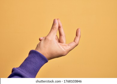 Hand of caucasian young man showing fingers over isolated yellow background snapping fingers for success, easy and click symbol gesture with hand - Shutterstock ID 1768103846