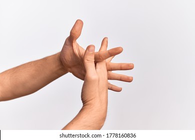 Hand of caucasian young man showing fingers over isolated white background stretching with fingers intertwined, hands together and fingers interlocked