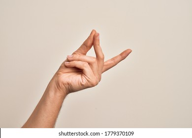 Hand of caucasian young man showing fingers over isolated white background snapping fingers for success, easy and click symbol gesture with hand - Shutterstock ID 1779370109
