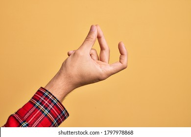 Hand of caucasian young man showing fingers over isolated yellow background snapping fingers for success, easy and click symbol gesture with hand - Shutterstock ID 1797978868