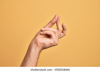 Hand of caucasian young man showing fingers over isolated yellow background snapping fingers for success, easy and click symbol gesture with hand - Powered by Shutterstock