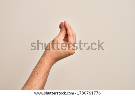 Hand of caucasian young man showing fingers over isolated white background doing Italian gesture with fingers together, communication gesture movement