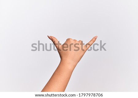 Hand of caucasian young woman gesturing Hawaiian shaka greeting gesture, telephone and communication symbol