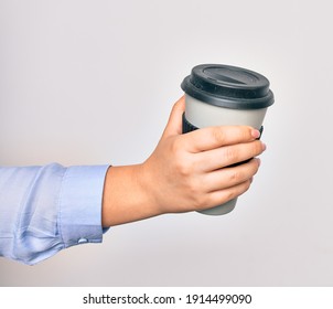 Hand Of Caucasian Young Woman Holding Cup Of Takeaway Coffee Over Isolated White Background