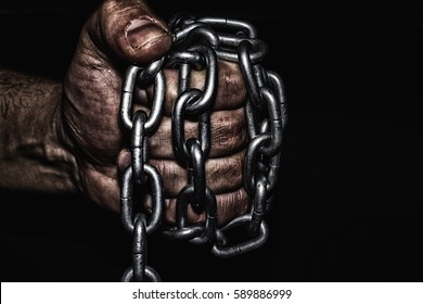Hand with CHAIN,chain in hand,the chain wound on the hand,dirty hands,black background