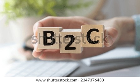 Hand change wooden cube block from B2C. E Commerce, marketing and strategy concepts