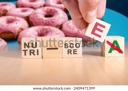 Hand changing the expression nutri-score A to nutri-score E. The Nutri-Score, also known as the 5-Colour Nutrition label or 5-CNL, is a five-colour nutrition label and nutritional rating system.