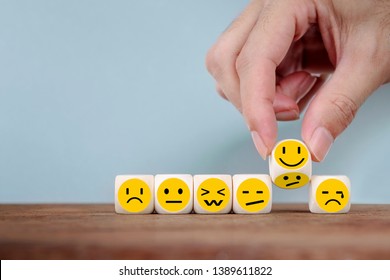 Hand Changing with smile emoticon icons  face on Wooden Cube,hand flipping unhappy turning to happy symbol - Shutterstock ID 1389611822