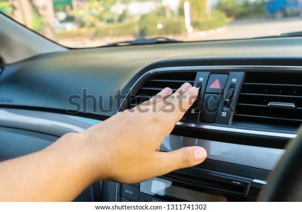  Hand checking the air conditioner in the car,\
The cooling system in the car 
