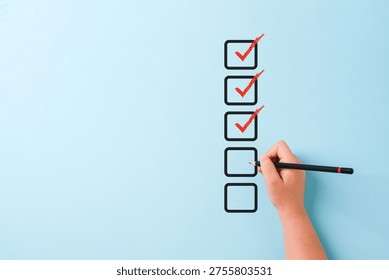 Hand checking checklist boxes representing task completion and productivity concept