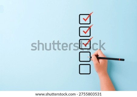 Hand checking checklist boxes representing task completion and productivity concept